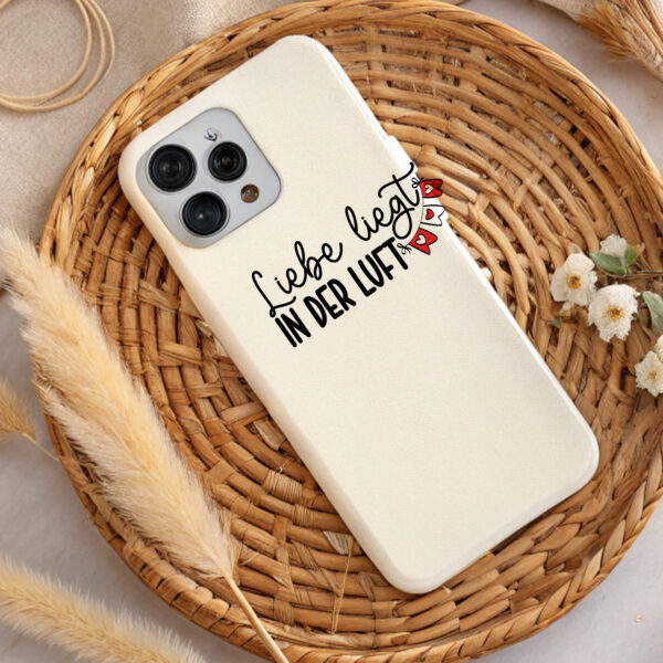 Cream phone case with "Love is in the air" design. Perfect Valentine's Day gift. DTF & sublimation ready.