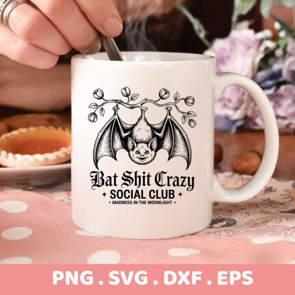 A white mug displays a "Bat Shit Crazy Social Club" design with a cartoon bat hanging from a branch, intended for cutting machines like Cricut and serigraphy applications for Halloween-themed apparel and accessories.