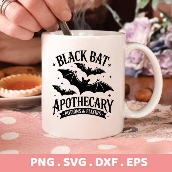 Close-up of a white mug featuring a "Bat Apothecary Cricut Design" with bats and text, intended for cutting or serigraphy applications.