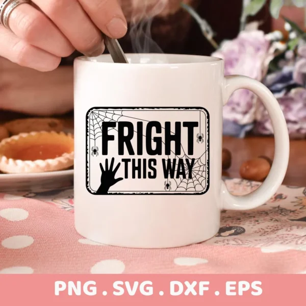 Close-up of a white mug featuring a "Fright This Way" design with spiderwebs and a hand, intended for Halloween-themed Cricut crafts.