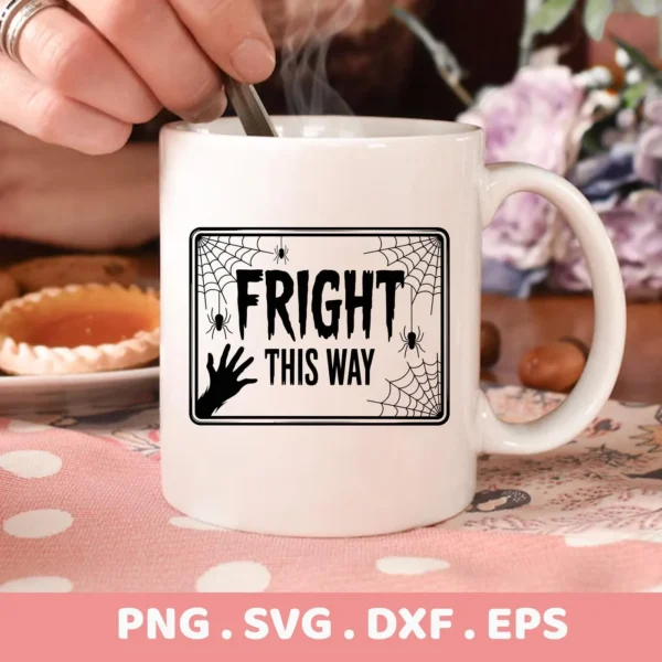 Close-up of a white mug featuring a "Fright This Way" design with spiderwebs and a spooky hand, intended for Halloween-themed Cricut crafts.