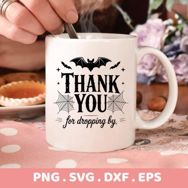 Close-up of a white mug featuring a "Halloween Thank You Cricut" design with bats and spiderwebs, intended for cutting or serigraphy applications.