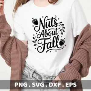 A woman wears a white t-shirt with a black "Nuts About Fall" design featuring acorns and decorative flourishes, intended for Cricut cutting and shirt serigraphy.
