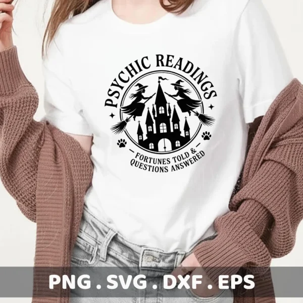 A white t-shirt displays a black Halloween Psychic Reading Cricut design featuring witches on broomsticks circling a haunted castle, suitable for cutting or serigraphy.