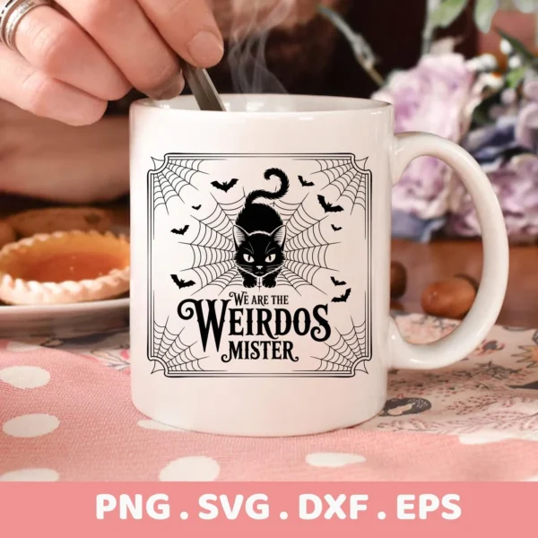 Close-up of a white mug featuring a "Halloween Weirdos Cricut Design" with a black cat, spiderwebs, and bats, intended for cutting or serigraphy applications.