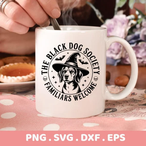 Close-up of a white mug featuring a Halloween dog Cricut design of a dog wearing a witch's hat, surrounded by "The Black Dog Society, Familiars Welcome," suitable for cutting or serigraphy.