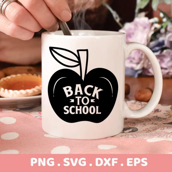 A white mug with a black apple design containing the words "Back To School" is being stirred, representing a Back To School SVG digital download bundle.