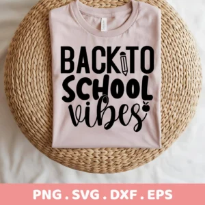 A light pink t-shirt with the text "Back To School Vibes" in black, featuring a pencil and apple graphic, displayed on a woven mat, representing a Back To School SVG digital download bundle.