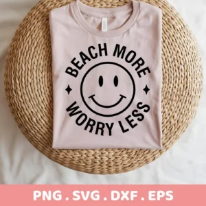 A light pink t-shirt with a black "Beach More Worry Less" design encircling a beach smiley face is displayed on a woven surface; this is a digital download bundle including SVG and PNG files.