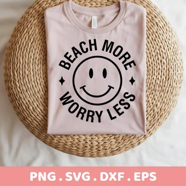 A light pink t-shirt with a black "Beach More Worry Less" design encircling a beach smiley face is displayed on a woven surface; this is a digital download bundle including SVG and PNG files.