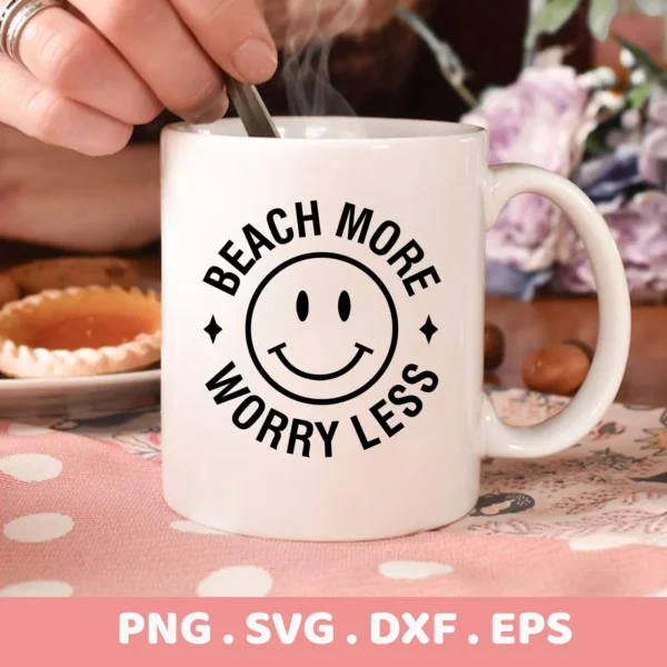 Close-up of a white mug with a "Beach More Worry Less" design featuring a beach smiley face SVG, indicating it's a digital download bundle including SVG and PNG files.
