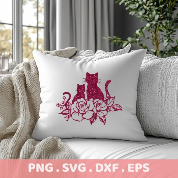 A white pillow on a couch displays a glittery, maroon-colored "Cats Roses Silhouette SVG" design featuring two cats sitting amongst roses; this is a digital download bundle including SVG and PNG files.