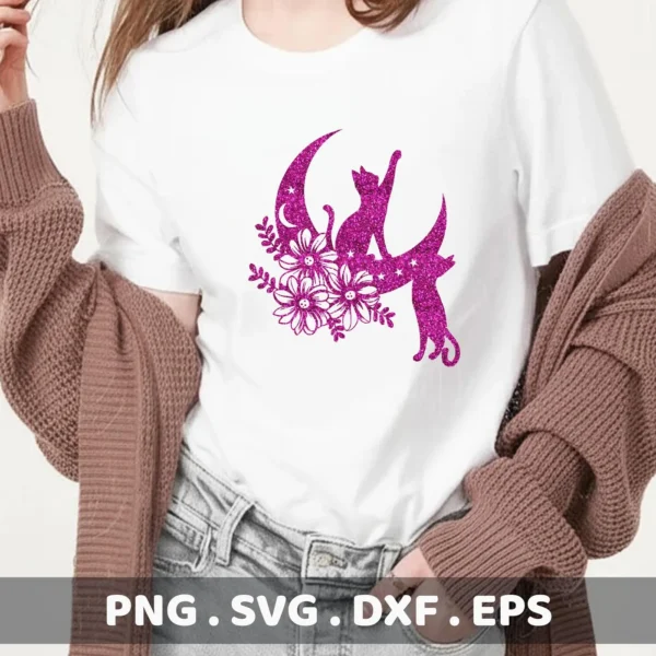 A pink glittery design on a white t-shirt shows two cats sitting on a crescent moon adorned with flowers and stars; this is a Floral Cats Moon SVG File digital download bundle including SVG and PNG formats.