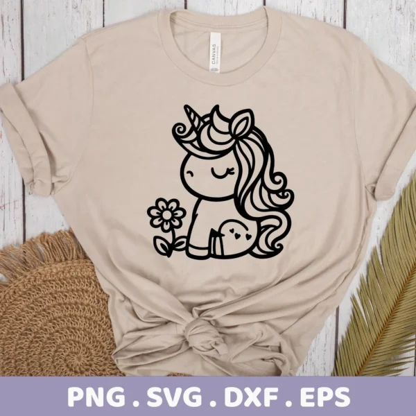 A beige t-shirt displays a cute unicorn SVG Cricut design, a digital download bundle including SVG and PNG files, featuring a stylized unicorn with a flower and heart details.