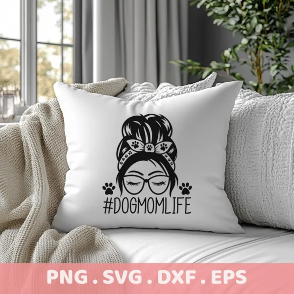 A white pillow on a couch displays a "Dog Mom Life SVG" design featuring a woman with glasses and a messy bun adorned with paw prints; this is a digital download bundle including SVG and PNG files.