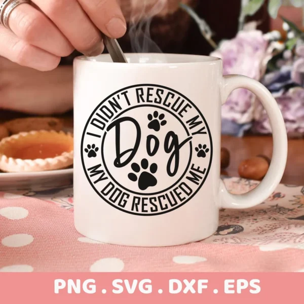 A white mug with the text "I didn't rescue my dog, my dog rescued me" and paw prints, showcasing a Rescue Dog SVG Cricut Design available as a digital download bundle (SVG, PNG).