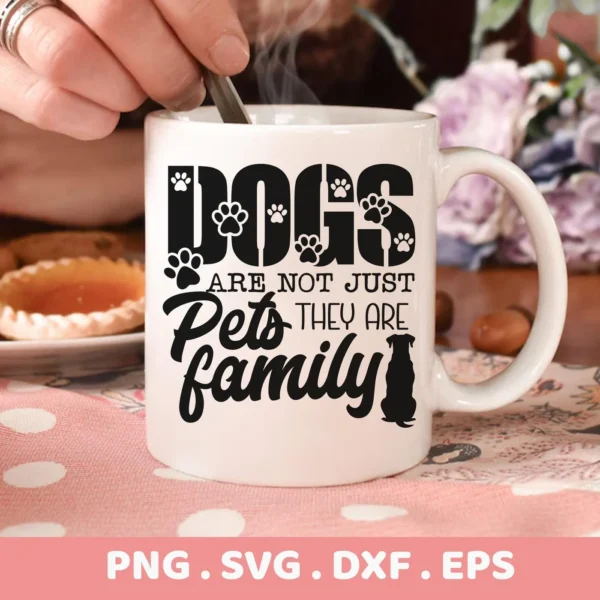 Close-up of a white mug with the text "Dogs are not just pets they are family" in black, decorated with paw prints and a dog silhouette, representing a Dogs Family SVG Cricut Design digital download bundle (SVG, PNG, DXF, EPS).