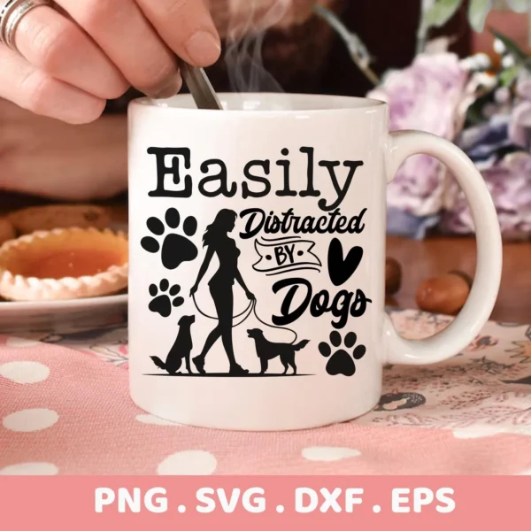 White mug displaying a "Easily Distracted By Dogs" design with paw prints and a silhouette of a woman walking two dogs, representing a Distracted Dogs SVG Cricut Design, available as a digital download bundle including SVG and PNG formats.