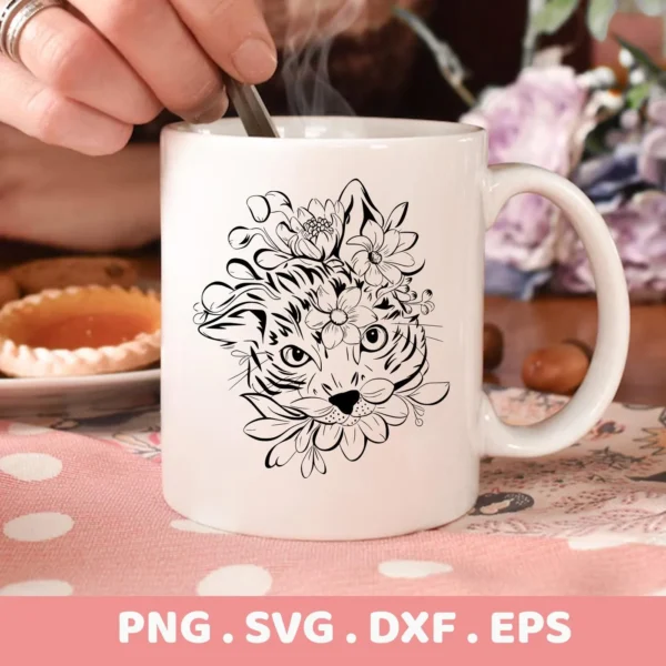 Close-up of a white mug featuring a Floral Cat SVG Cricut Design, a digital download bundle (SVG, PNG, DXF, EPS) of a cat's head adorned with flowers.