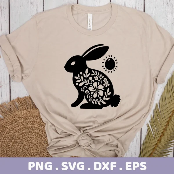 A beige t-shirt displays a black silhouette of a floral Easter bunny, representing a digital download bundle including SVG and PNG files.