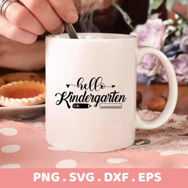 Close-up of a white mug featuring a "Hello Kindergarten" SVG design with a pencil and ruler graphic, presented as a digital download bundle (SVG, PNG).