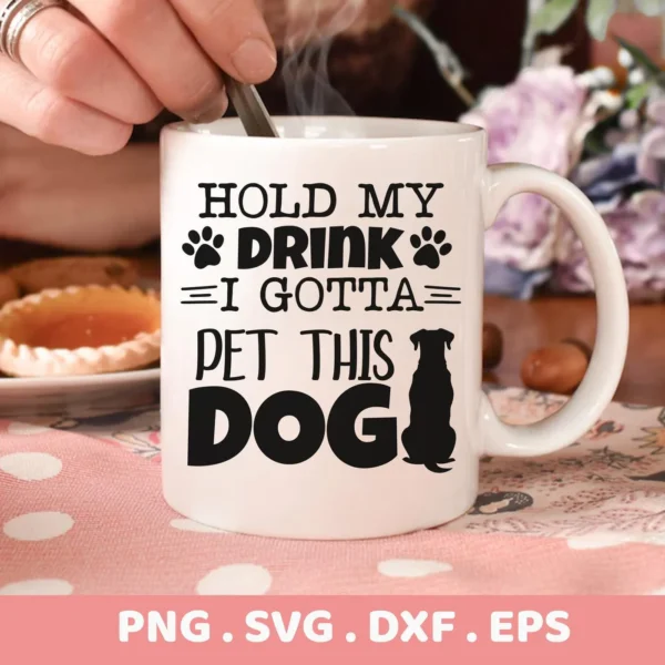 Close-up of a white mug with the text "Hold My Drink I Gotta Pet This Dog" and paw print graphics, showcasing a digital download bundle including SVG and PNG files.