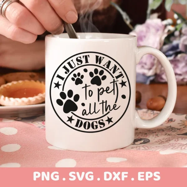 Close-up of a white mug with the design "I Just Want To Pet All The Dogs" surrounded by paw prints and stars, presented as a digital download bundle (SVG, PNG).