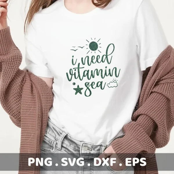A woman wearing a white t-shirt with a green glittery design that reads "I need vitamin sea" with a sun, birds, a starfish, and a cloud, representing a Starfish SVG Beach Decor digital download bundle (SVG, PNG).