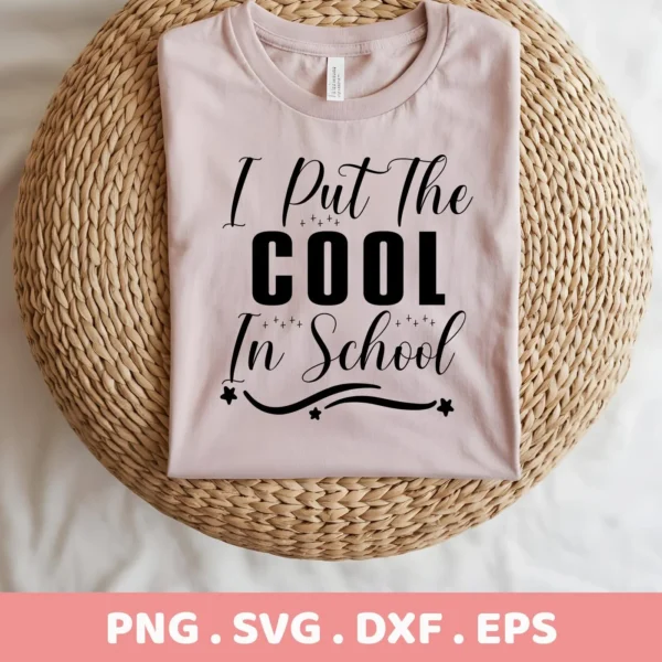 A folded light pink t-shirt with the text "I Put The COOL In School" in black lettering, displayed on a round woven mat, representing a Cool School SVG Design available as a digital download bundle (SVG, PNG).