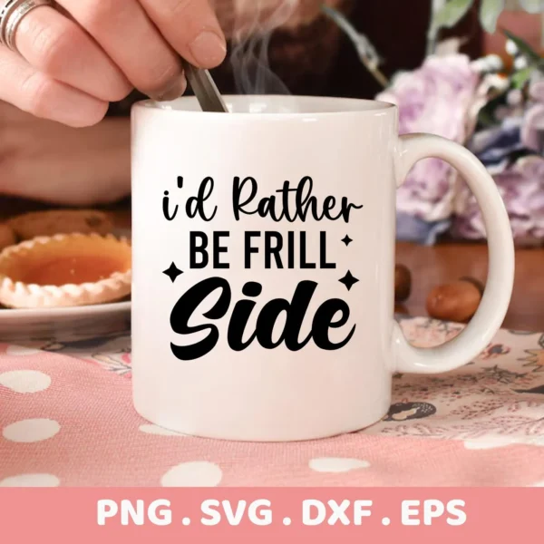 A white mug with the text "I'd Rather Be Frill Side" in black lettering, showcasing the Frill Side SVG Design, part of a digital download bundle including SVG and PNG formats.