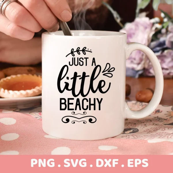 Close-up of a white mug with the text "Just A Little Beachy" in decorative fonts, part of a digital download bundle (SVG, PNG).