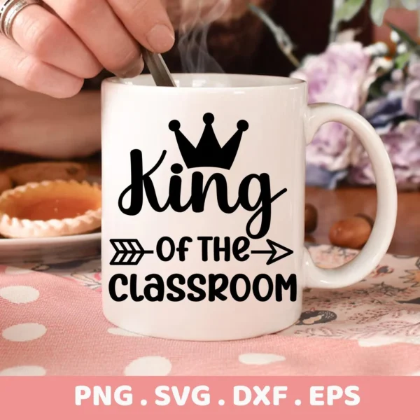 Close-up of a white mug featuring the "King Classroom SVG Design" with a crown and arrow graphic, indicating it's a digital download bundle (SVG, PNG, DXF, EPS).