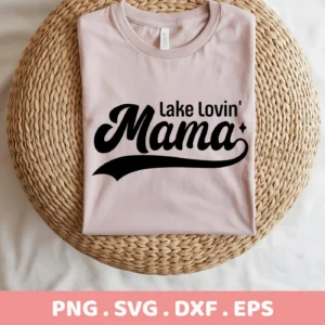 A folded light pink t-shirt with the text "Lake Lovin' Mama" in a retro font is displayed on a woven mat; this is a Lake Lovin' Mama SVG digital download bundle.