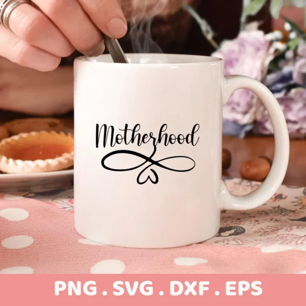 Close-up of a white mug with the word "Motherhood" and a heart design, representing a Motherhood SVG for Cricut digital download bundle (SVG, PNG).