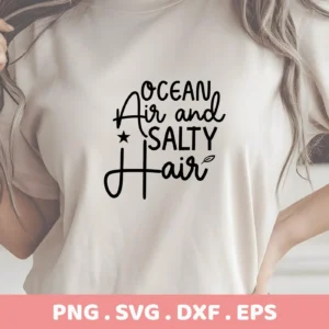 Close-up of a woman's torso wearing a t-shirt with the text "Ocean Air and Salty Hair" in a stylized font, representing a Salty Hair SVG Cricut Design digital download bundle (SVG, PNG).