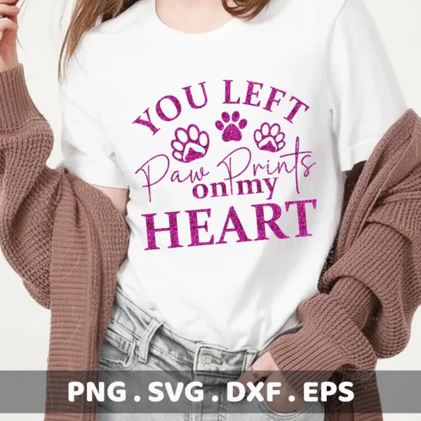 A woman wearing a white t-shirt with the text "You Left Paw Prints on my Heart" and paw print graphics, showcasing a Paw Prints Heart SVG digital download bundle (SVG, PNG).