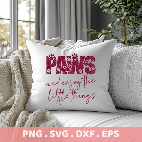 A white throw pillow on a couch displays the text "Paws and enjoy the little things" in a stylized font with paw print details, representing a Paws SVG Enjoy Little Things digital download bundle (SVG, PNG).