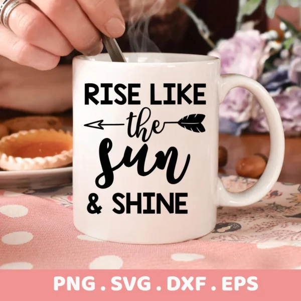 Close-up of a white mug with the text "Rise Like the Sun & Shine" in black, featuring an arrow through the word "the," presented as a digital download bundle (SVG, PNG, DXF, EPS).