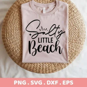A folded light pink t-shirt with the text "Salty Little Beach" in black script and sans-serif fonts, displayed on a round woven mat; this is a Salty Little Beach SVG digital download bundle.