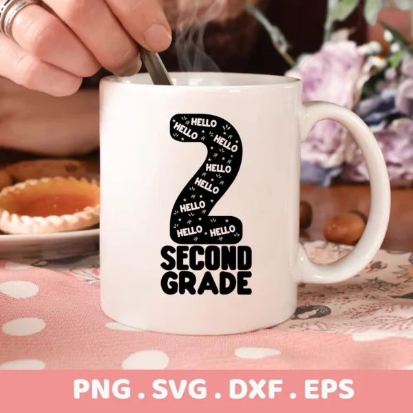 Close-up of a white mug featuring a "Second Grade SVG Design" with a large number two filled with "Hello" text and stars, indicating a back-to-school theme; this is a digital download bundle including SVG and PNG files.