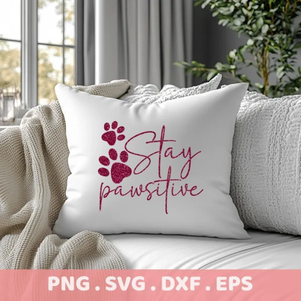 Close-up of a white throw pillow with a glittery maroon "Stay Pawsitive" design and paw prints, showcasing a digital download bundle including SVG and PNG files.