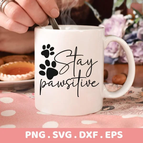 Close-up of a white mug with the text "Stay Pawsitive" and paw prints, representing a Stay Pawsitive SVG Cricut Design digital download bundle (SVG, PNG).