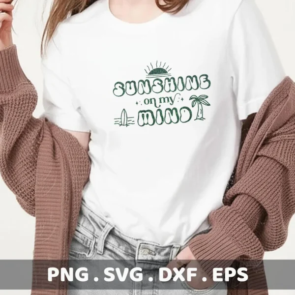A woman wearing a white t-shirt with the green text "Sunshine on my Mind" featuring a sun, surfboard, and palm tree graphic, showcasing a Sunshine Mind SVG Cricut Design available as a digital download bundle (SVG, PNG).