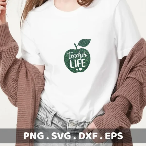 A woman wearing a white t-shirt with a green apple design containing the words "Teacher Life" and two small hearts, representing a Teacher Life Apple SVG digital download bundle (SVG, PNG).