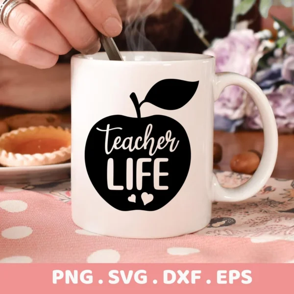 A white mug with a black apple silhouette design containing the text "Teacher Life" and two small hearts, representing a Teacher Life Apple SVG digital download bundle (SVG, PNG, DXF, EPS).