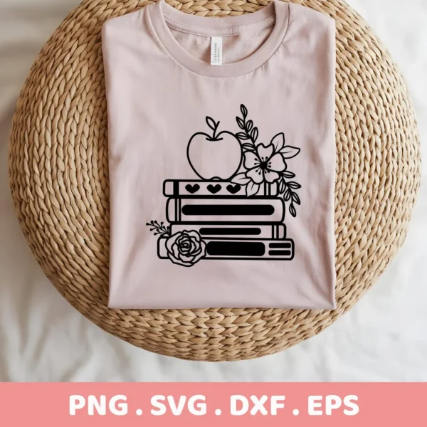 A light pink t-shirt displays a black "Floral Books Apple SVG" design, featuring an apple, floral accents, and stacked books, showcased as a digital download bundle for Cricut and Silhouette crafting.