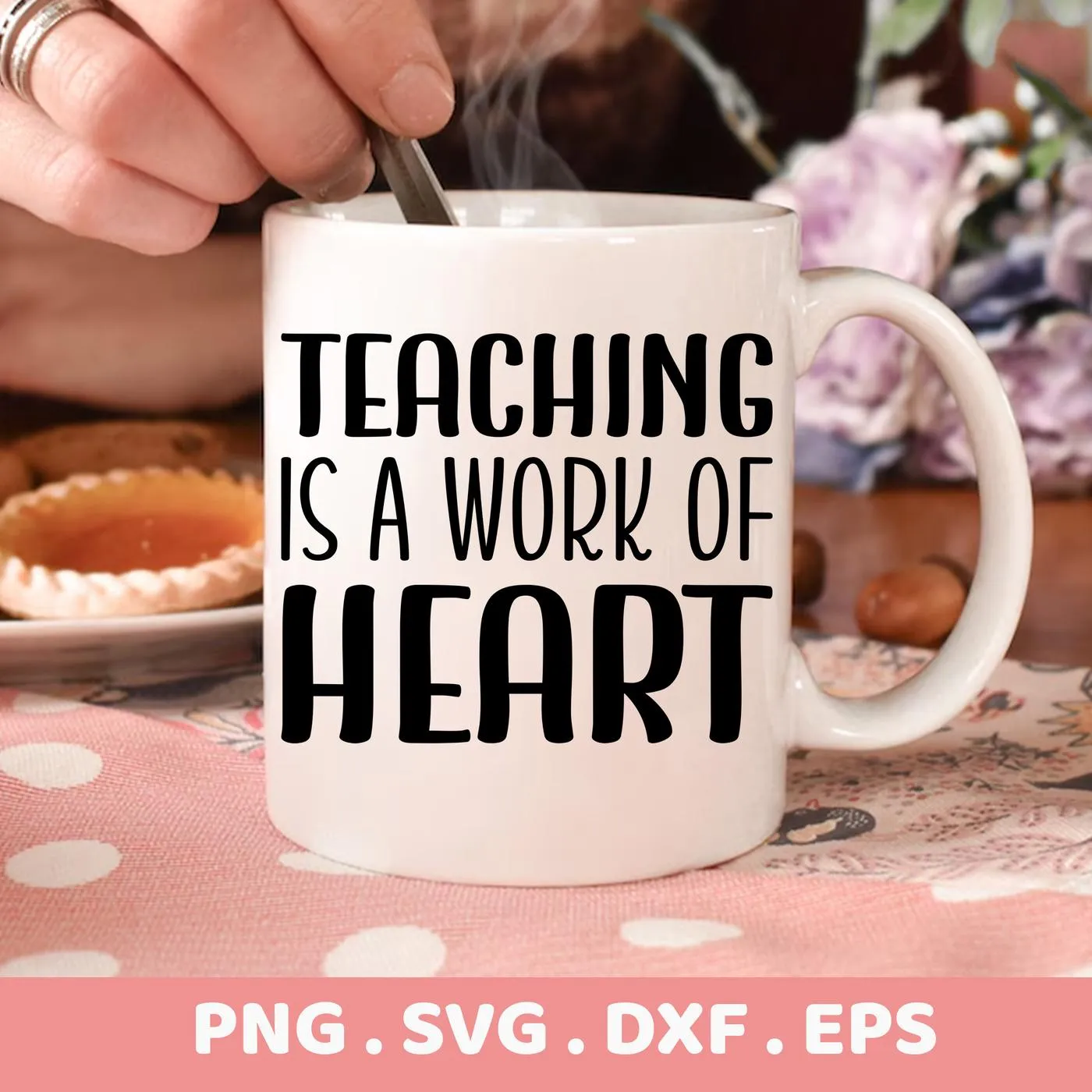 Close-up of a white mug with the text "Teaching is a work of heart" in bold black letters, presented as a Teaching Heart SVG Design digital download bundle (SVG, PNG, DXF, EPS).