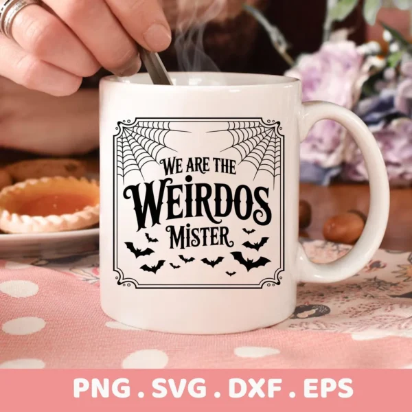 Close-up of a white mug featuring a "We Are The Weirdos Mister" Cricut Design with spiderwebs and bats, intended for Halloween-themed cutting or serigraphy projects.