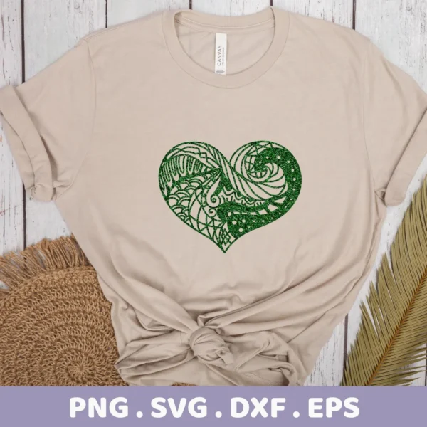 A beige t-shirt displays a green, glittery, intricately patterned Zentangle Heart SVG File design, representing a digital download bundle.