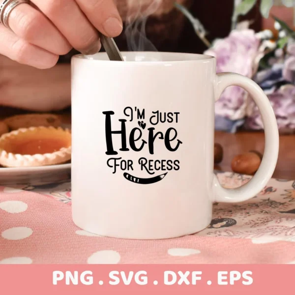 White mug mockup with "I'm Just Here For Recess" design, a Recess SVG file for Cricut, Silhouette, and other cutting machines.